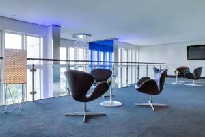 a room with a chair and a table in it at Radisson Blu Hotel, Hamburg in Hamburg