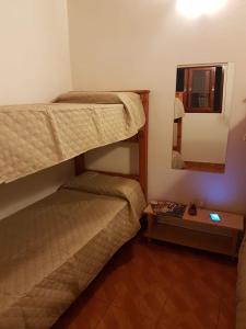 a bedroom with two bunk beds and a mirror at Accueillant Salta in Salta