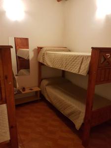 a bunk bed in a room with a mirror at Accueillant Salta in Salta