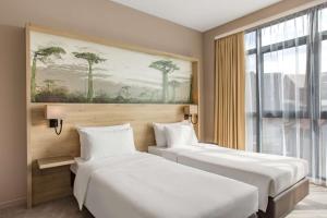 Postel nebo postele na pokoji v ubytování Radisson Serviced Apartments Antananarivo City Centre