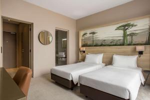 Postel nebo postele na pokoji v ubytování Radisson Serviced Apartments Antananarivo City Centre