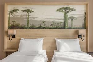 Postel nebo postele na pokoji v ubytování Radisson Serviced Apartments Antananarivo City Centre