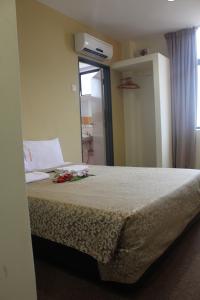 a bedroom with a bed with flowers on it at Grand Inn Hotel - Macalister Road in George Town