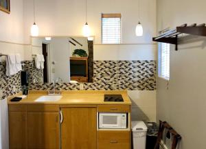 a kitchen with a stove, sink, microwave, and refrigerator at Tyrolean Lodge in Aspen