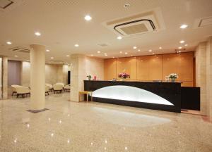 a lobby with a reception desk in a building at Smile Hotel Nara in Nara