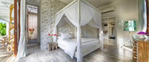 a bedroom with a white canopy bed in a room at Pure Villa Bali by Nagisa Bali in Dalung +33 photos
