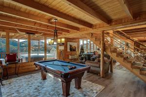 a billiard room with a pool table and stairs at Majestic Luxury 3bed/3.5 Bath with Spectacular Views in Wears Valley! in Sevierville