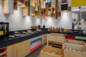a kitchen with a counter with food on it at Atura Adelaide Airport in Adelaide