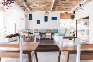 a living room with wooden tables and a blue couch at Canggu Village Accommodation in Canggu
