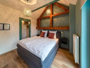 a bedroom with a large bed in a room at Holiday home in Waimes on the shores of Lake Roberville in Waimes