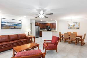 a living room with a couch and a table at Gorgeous Condo Near Disney in Orlando