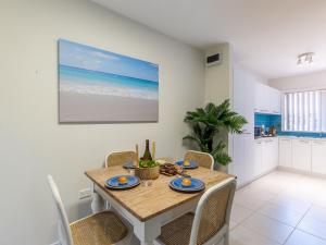 a kitchen and dining room with a table and chairs at Fingal Court 2 2 Lentara St in Fingal Bay
