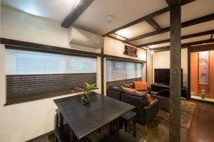 a living room with a table and a couch at Rinn Kiyomizu Villa in Kyoto