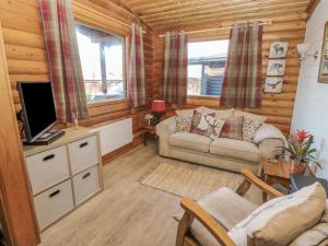 a living room with a couch and a tv at Ingram in Morpeth