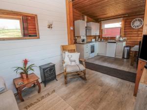 a kitchen and living room in a log cabin at Ingram in Morpeth