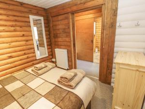 a bedroom with a bed in a wooden room at Ingram in Morpeth