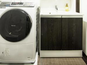 a washer and dryer sitting next to a sink at Rinn Kiyomizu Villa in Kyoto