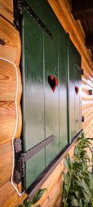 a window with a heart on the side of a house at Planinska kuća "Sedam Vlašića" in Vlasic