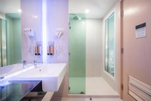 a bathroom with a sink and a shower at Sonia residence - SHA Extra Plus in Jomtien Beach +59 photos