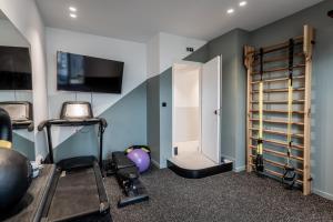 a room with a gym with a treadmill and a door at Athinaion Recreation Suites in Athens