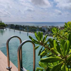 a view of a body of water from a balcony at Modern apartment in close proximity to the Beach in Colombo