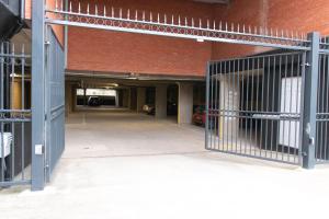 an entrance to a building with a metal gate at LiveStay-Modern Apartment Minutes Away From Heathrow in Slough