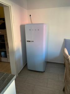 a white refrigerator in the corner of a kitchen at Carpe diem in Speyer