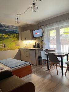 Pokoje Beata في فيسلا: غرفة معيشة مع مطبخ وغرفة طعام