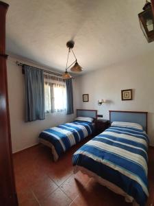 1 dormitorio con 2 camas y ventana en Casa Javier y Casa Eva, en Puerto del Rosario