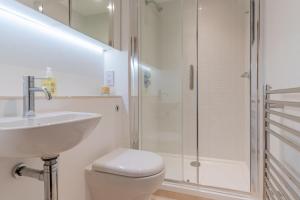 a bathroom with a sink and a toilet and a shower at The Barracks in Northleach +26 photos