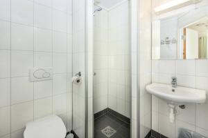 a bathroom with a shower and a sink at Flåm Hostel in Flåm