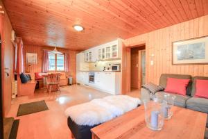 a living room with a couch and a table at Chalet Castellani Apartment in Fiesch +12 photos