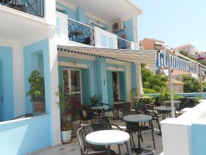 a row of tables and chairs outside of a building at Zorbas Hotel & Studios in Pythagoreio