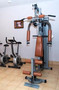 a gym with several exercise bikes in a room at Hotel Pušyno Namai in Tirkšliai