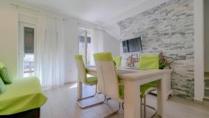 a room with a desk and chairs and a tv at Sebastian in Novigrad Istria