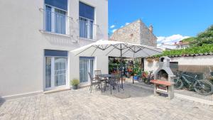 a patio with an umbrella and a table and chairs at Sebastian in Novigrad Istria