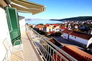 a balcony with a view of a city and the water at Apartments Nakir in Slatine