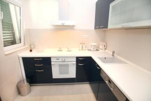 a kitchen with a sink and a white counter top at Apartments Nakir in Slatine +42 photos