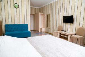 a hotel room with a bed and a tv at Gostinitsa Sultan in Aktobe