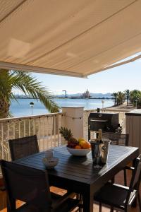 a table with a bowl of fruit on a patio at Fantastic, Front line, Penthouse Apartment with amazing views in Los Urrutias