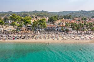 an aerial view of a beach with chairs and umbrellas at Tridente Mare Apart Hotel in Pefkohori