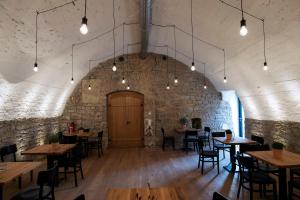 a room with tables and chairs and a brick wall at Martins Hotel in Schweinfurt