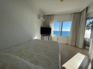 a bedroom with a bed and a view of the ocean at Hotel Paraíso Del Mar in Nerja