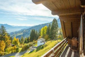 a balcony of a house with a view of a mountain at Chalet Ruedi - CharmingStay in Flumserberg
