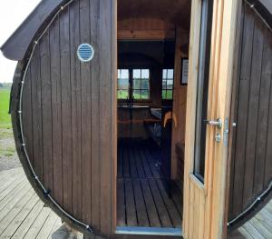 an inside view of a wooden building with a door at Sjötorp säteri & stugby in Larv