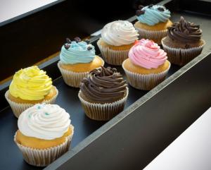 a tray of cupcakes with different colored frosting at The Raintree, St. Mary’s Road in Chennai