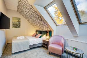 En eller flere senge i et værelse på Hotel Willa Tatrzańska