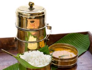 a pot of rice and a bowl of curry at The Raintree, St. Mary’s Road in Chennai
