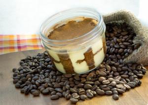 a cup of coffee sitting on a pile of coffee beans at The Raintree, St. Mary’s Road in Chennai