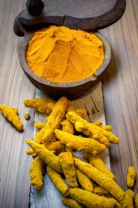 a bowl of turmeric sitting next to a pile ofumes at The Raintree, St. Mary’s Road in Chennai